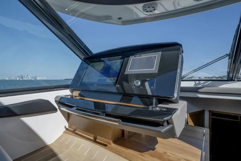 Slide: The Image of 2024 Tiara Yachts EX 60 helm station with advanced navigation system. - 35