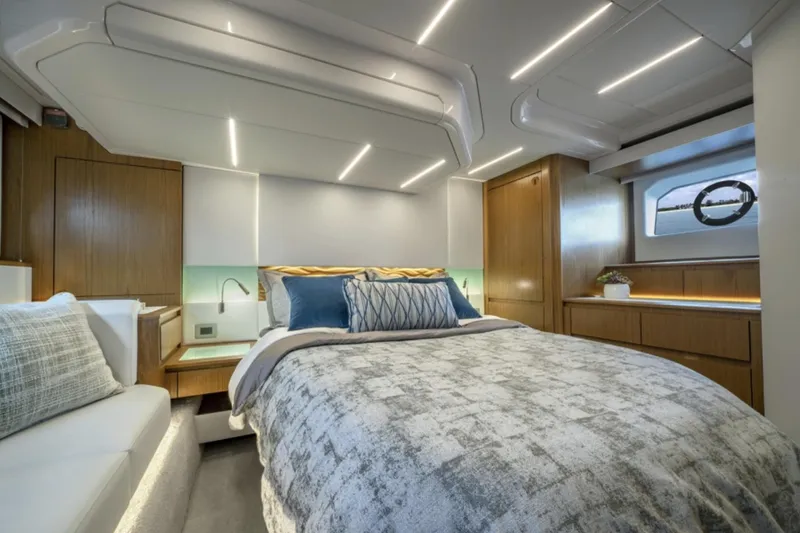 Slide: The Image of Luxurious bedroom interior of 2024 Tiara Yachts EX 60 with modern lighting and cozy bedding. - 37