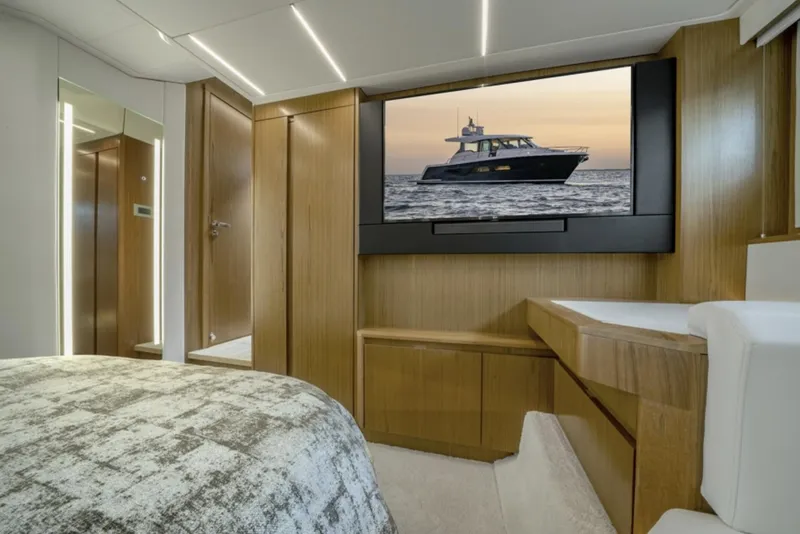 Slide: The Image of Luxurious interior of 2024 Tiara Yachts EX 60 with modern wood finishes and large TV. - 40