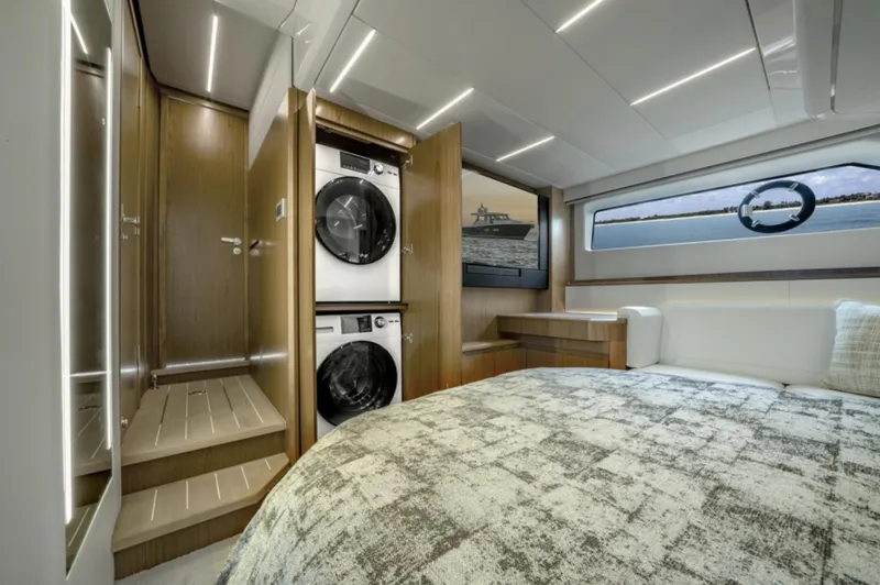 Slide: The Image of 2024 Tiara Yachts EX 60 interior with washer-dryer, bed, and window view. - 41