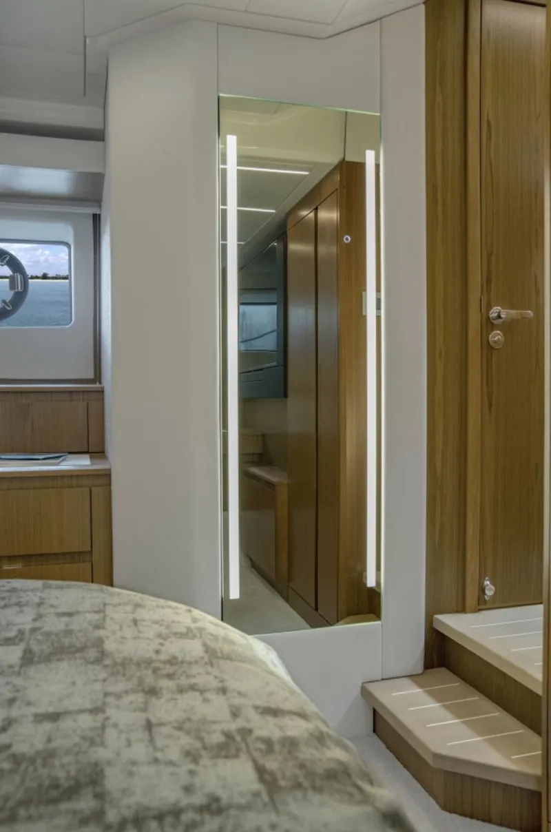 Slide: The Image of 2024 Tiara Yachts EX 60 interior cabin with modern wooden finishes. - 44