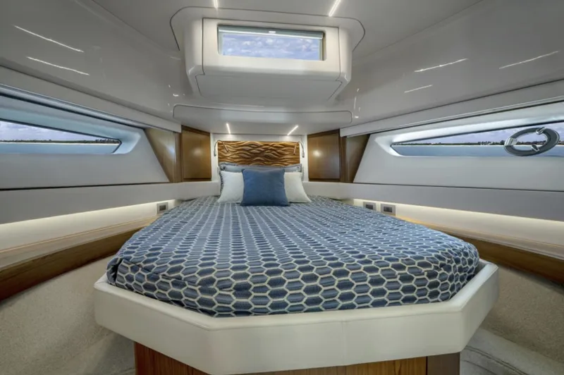 Slide: The Image of Luxurious bedroom interior of 2024 Tiara Yachts EX 60 with modern design and ample natural light. - 45