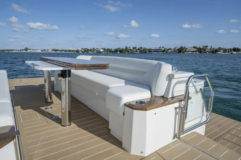 Slide: The Image of 2024 Tiara Yachts EX 60 luxury yacht deck with seating and table. - 7