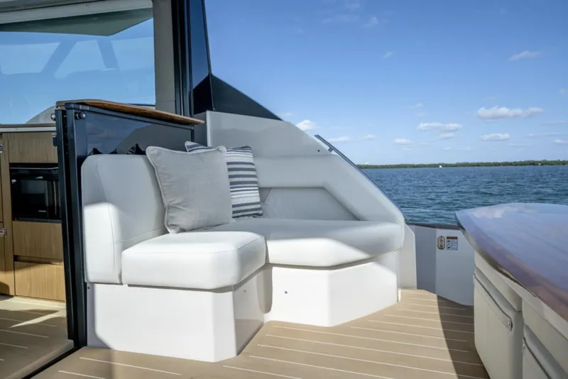 Slide: The Image of 2024 Tiara Yachts EX 60 seating area with ocean view and cushions. - 8