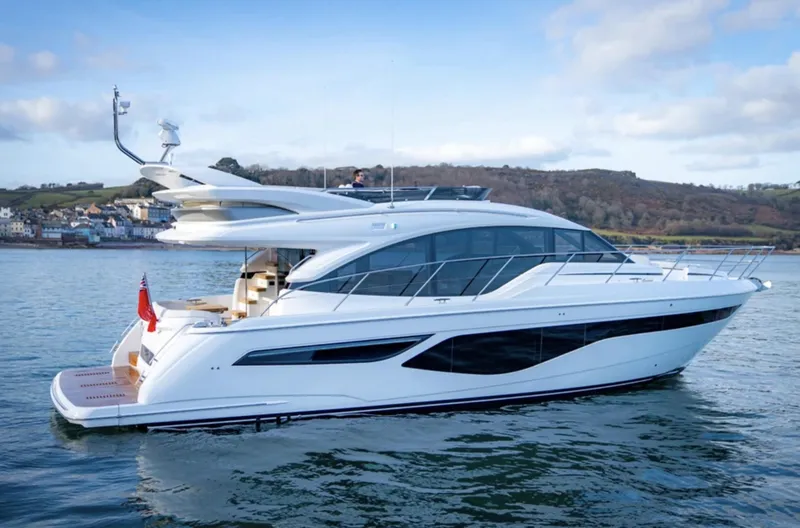 Slide: The Image of 2025 Princess F55 yacht on calm water with scenic background. - 0