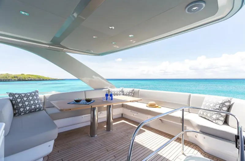 Slide: The Image of Luxurious 2025 Princess F55 yacht deck with ocean view, modern seating, and dining area. - 14