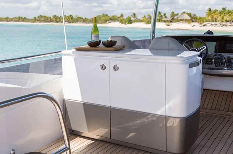 Slide: The Image of Luxury Princess F55 yacht interior, 2025 model, with ocean view and wine setup. - 16