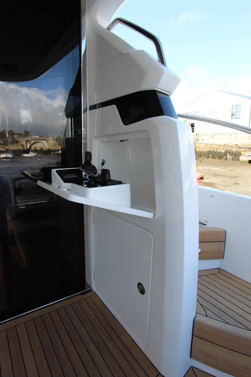Slide: The Image of 2025 Princess F55 yacht exterior with sleek white design and wooden deck. - 18