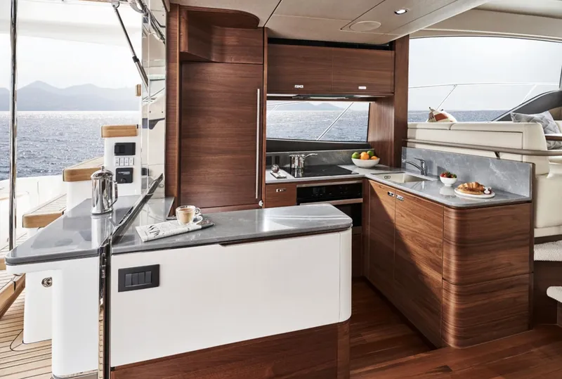 Slide: The Image of Luxurious kitchen on the 2025 Princess F55 yacht with modern wood cabinetry and ocean view. - 20