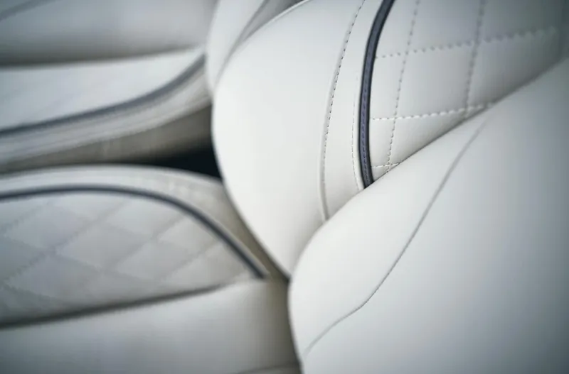 Slide: The Image of Close-up of luxurious white leather seats in the 2025 Princess F55 yacht. - 32