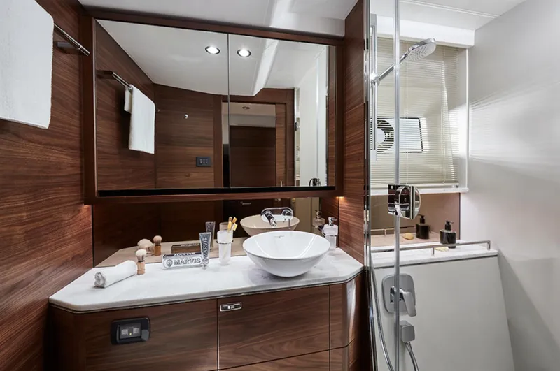 Slide: The Image of Luxurious bathroom in 2025 Princess F55 yacht with modern fixtures and wooden cabinetry. - 36
