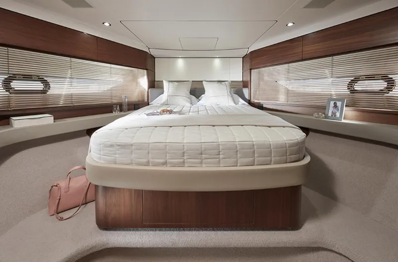 Slide: The Image of Luxurious bedroom in 2025 Princess F55 yacht with modern decor and ample natural light. - 37