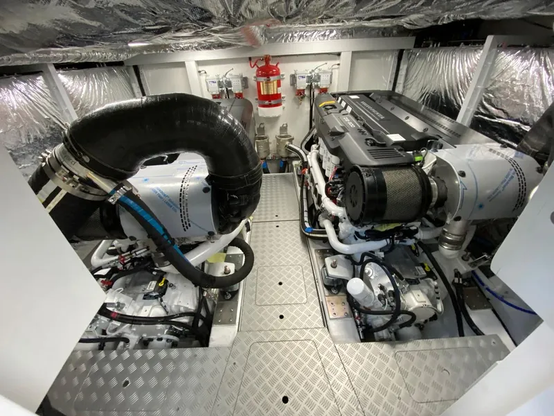 Slide: The Image of Engine room of a 2025 Princess F55 yacht with dual engines and fire extinguisher. - 46