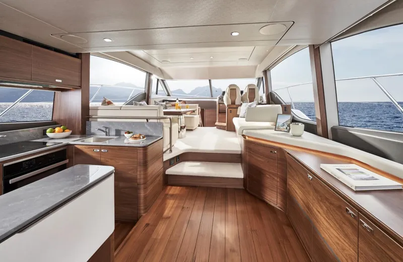 Slide: The Image of Luxurious interior of the 2025 Princess F55 yacht with modern kitchen and seating area. - 49