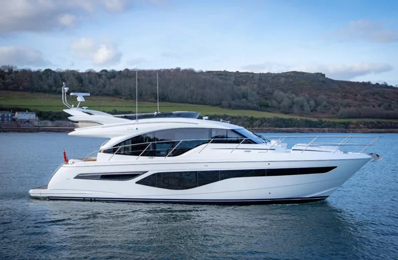 Slide: The Image of 2025 Princess F55 yacht cruising on a serene lake with a scenic backdrop. - 5