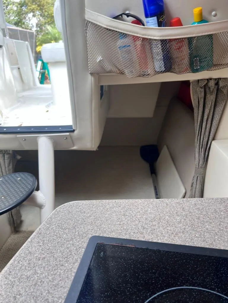 Slide: The Image of Interior of a 2005 Maxum 2500 SCR boat with storage and seating area. - 15