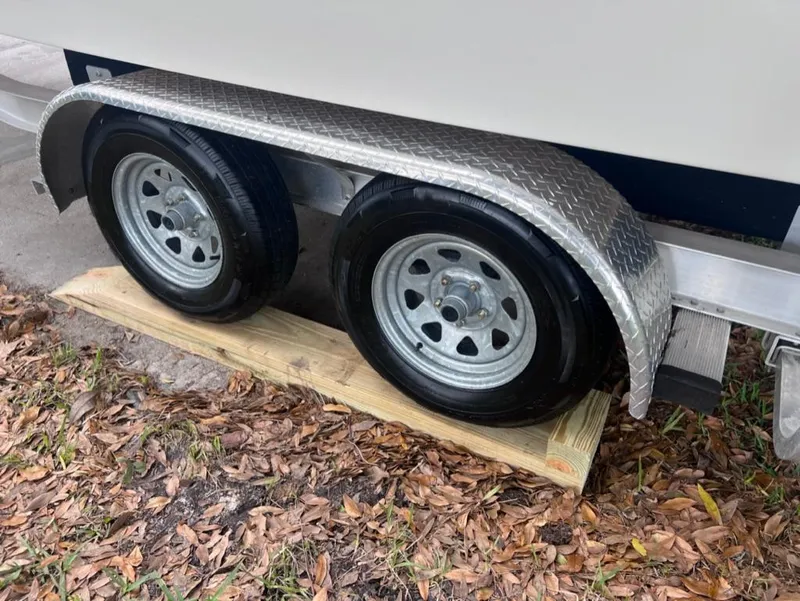 Slide: The Image of Dual axle trailer of a 2005 Maxum 2500 SCR boat on wooden blocks. - 17