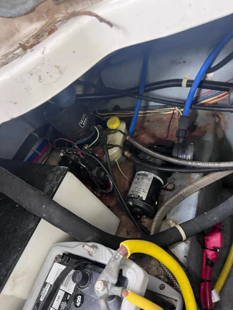 Slide: The Image of Engine compartment of a 2005 Maxum 2500 SCR boat with various components and wiring. - 19