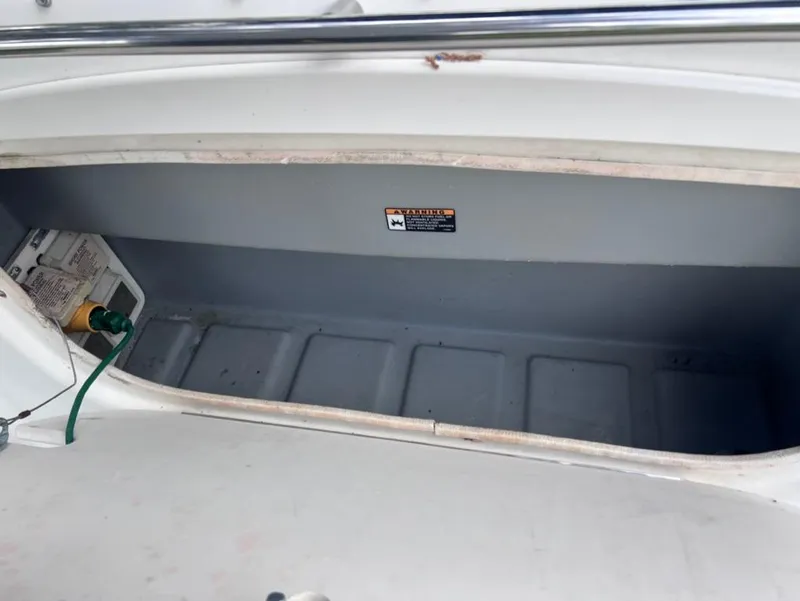Slide: The Image of Storage compartment of a 2005 Maxum 2500 SCR boat with electrical components. - 21