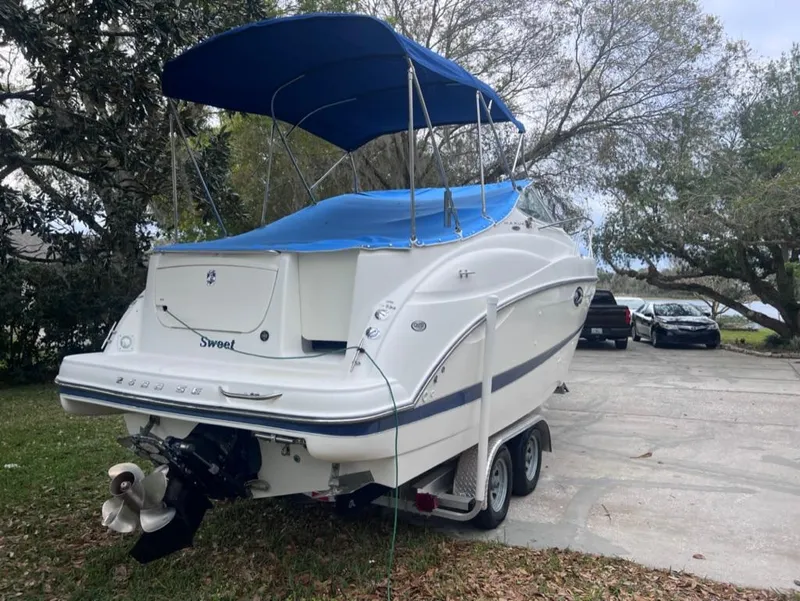 Slide: The Image of 2005 Maxum 2500 SCR boat with blue canopy on trailer. - 3