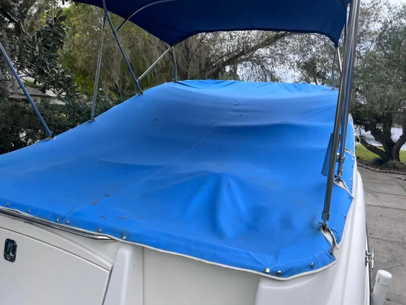 Slide: The Image of 2005 Maxum 2500 SCR boat with blue cover and canopy. - 5