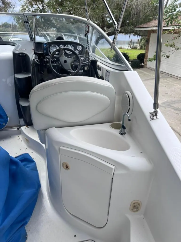 Slide: The Image of 2005 Maxum 2500 SCR boat interior with steering wheel and sink. - 7