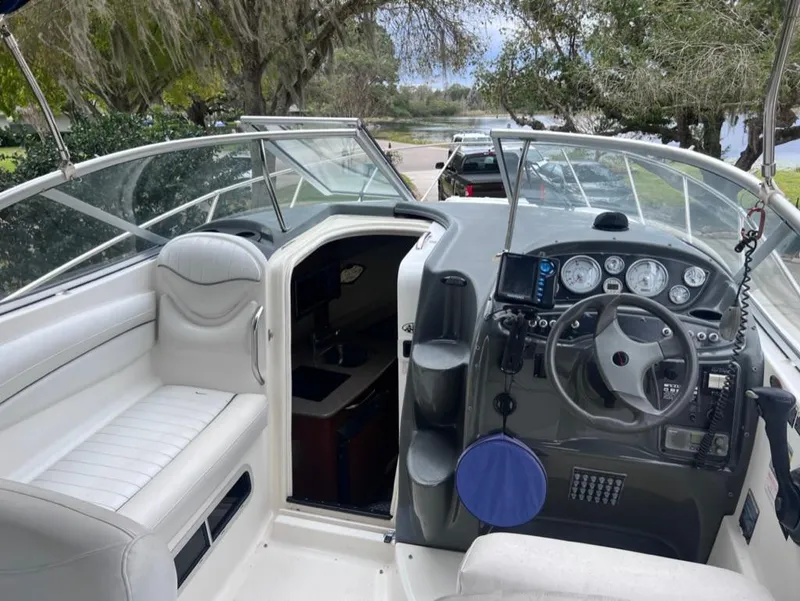 Slide: The Image of 2005 Maxum 2500 SCR boat interior with helm and seating area. - 8