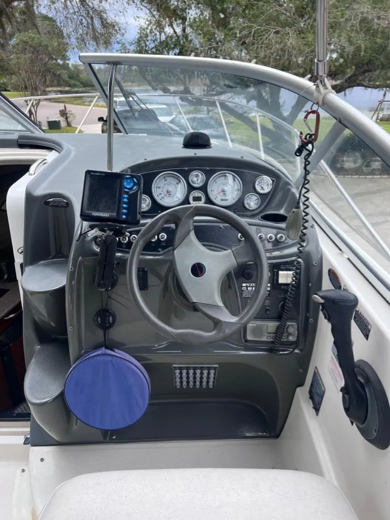 Slide: The Image of 2005 Maxum 2500 SCR boat dashboard with steering wheel and navigation equipment. - 9
