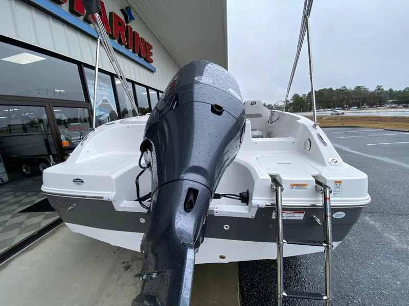 Slide: The Image of 2023 Hurricane SunDeck Sport 188 OB boat with outboard motor, displayed at a dealership. - 7