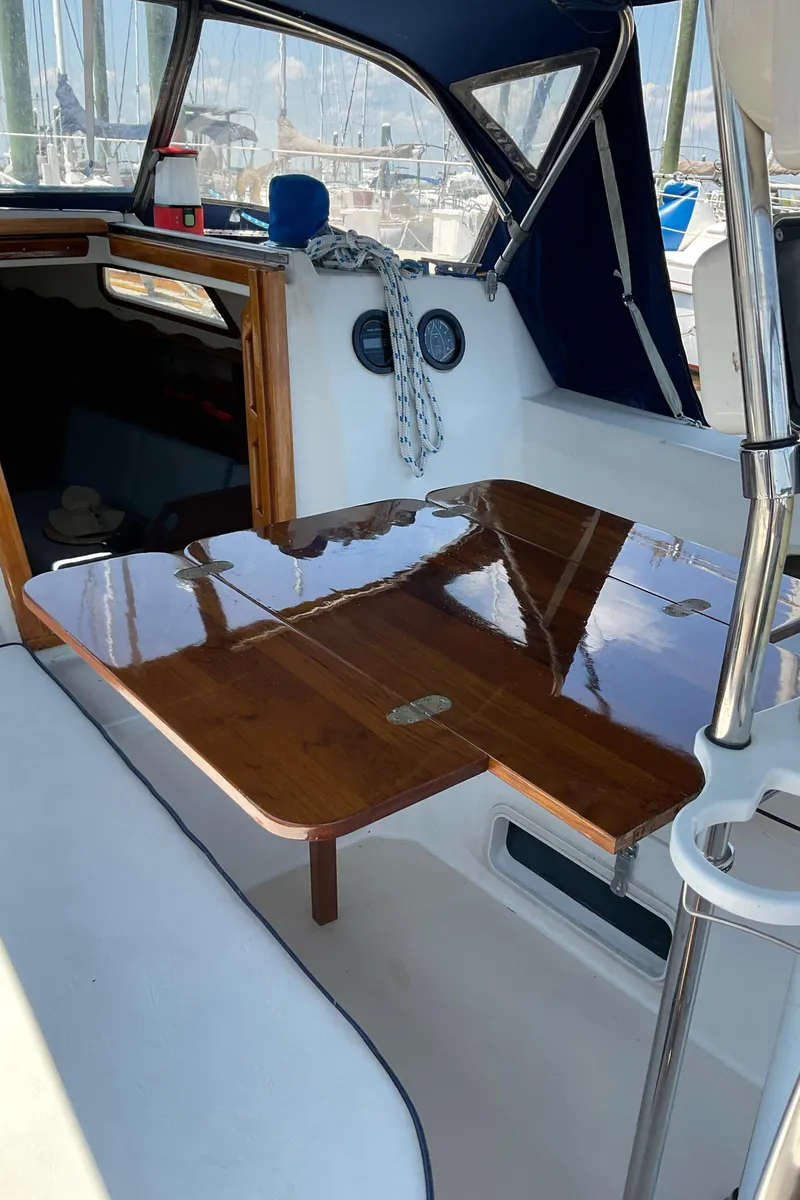 Slide: The Image of 1989 Sabre 34 MK II sailboat cockpit with polished wooden table. - 13