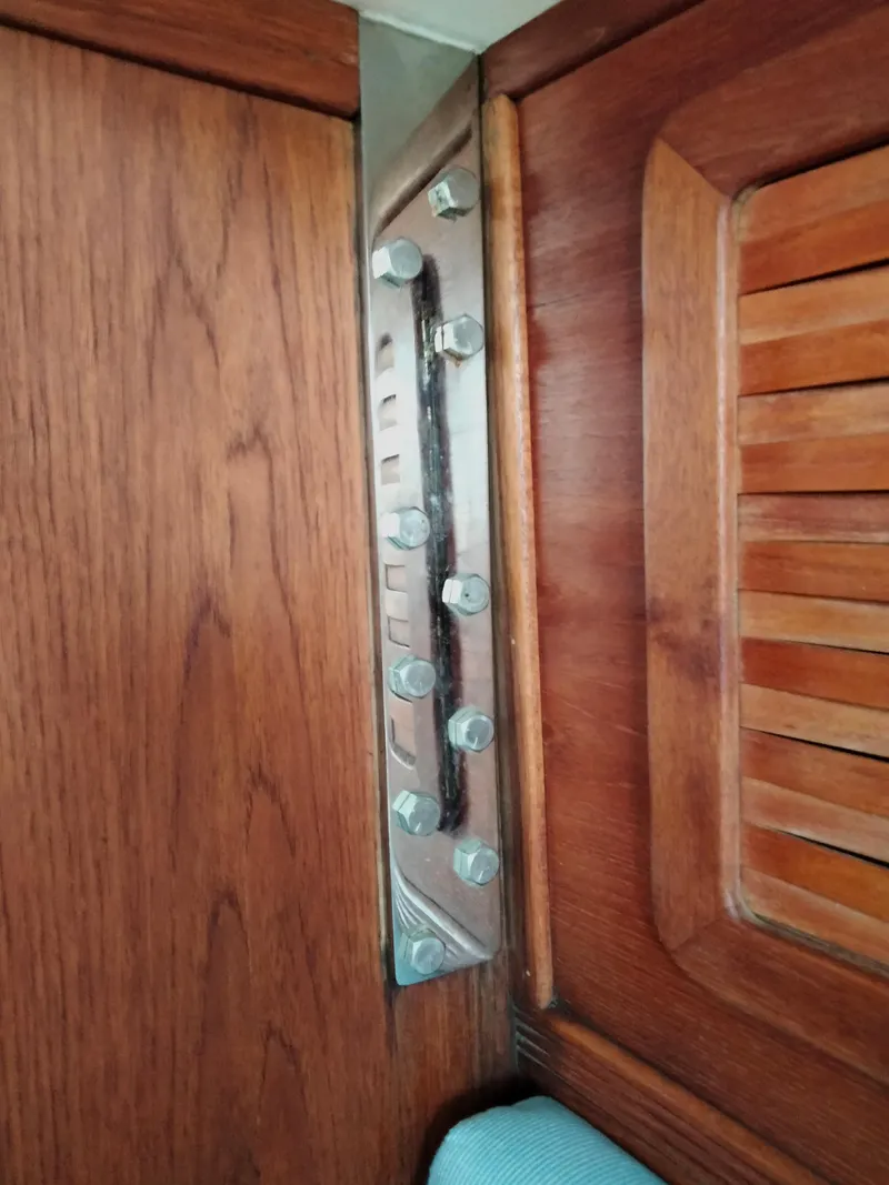 Slide: The Image of Close-up of interior woodwork and metal bolts on a 1989 Sabre 34 MK II sailboat. - 17
