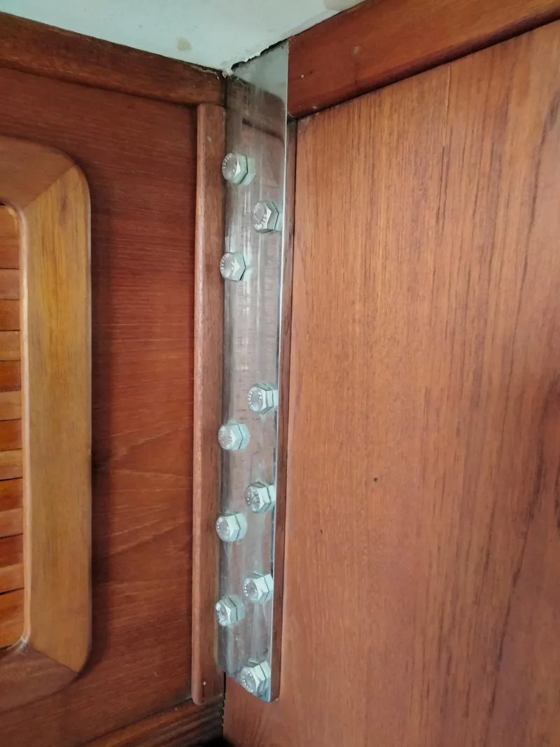 Slide: The Image of Metal bracket with bolts on wooden interior of 1989 Sabre 34 MK II sailboat. - 18