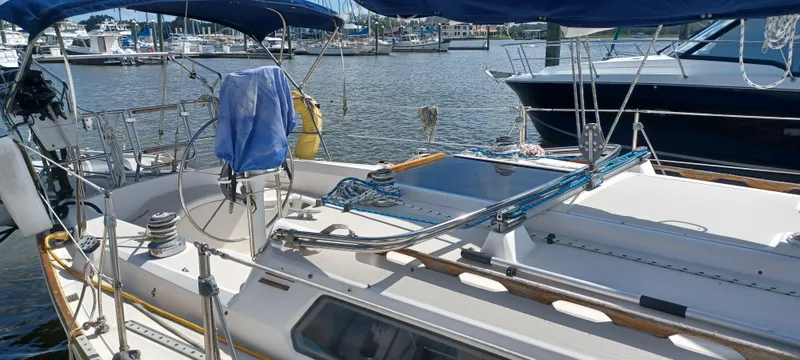 Slide: The Image of 1989 Sabre 34 MK II sailboat docked at marina, featuring spacious deck and rigging. - 2