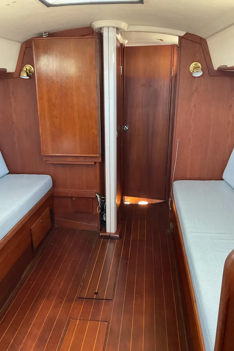 Slide: The Image of Interior of 1989 Sabre 34 MK II sailboat with wooden finishes and blue cushions. - 21