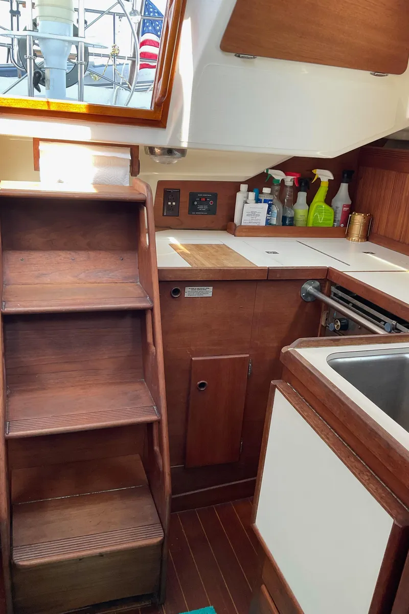 Slide: The Image of 1989 Sabre 34 MK II yacht interior kitchen with wooden cabinetry and stairs. - 24
