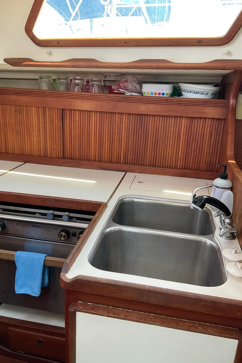 Slide: The Image of 1989 Sabre 34 MK II yacht kitchen with double sink and wooden cabinetry. - 26