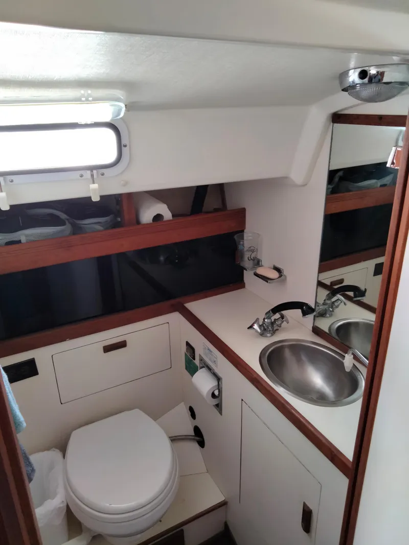 Slide: The Image of 1989 Sabre 34 MK II sailboat bathroom with sink, toilet, and storage. - 30