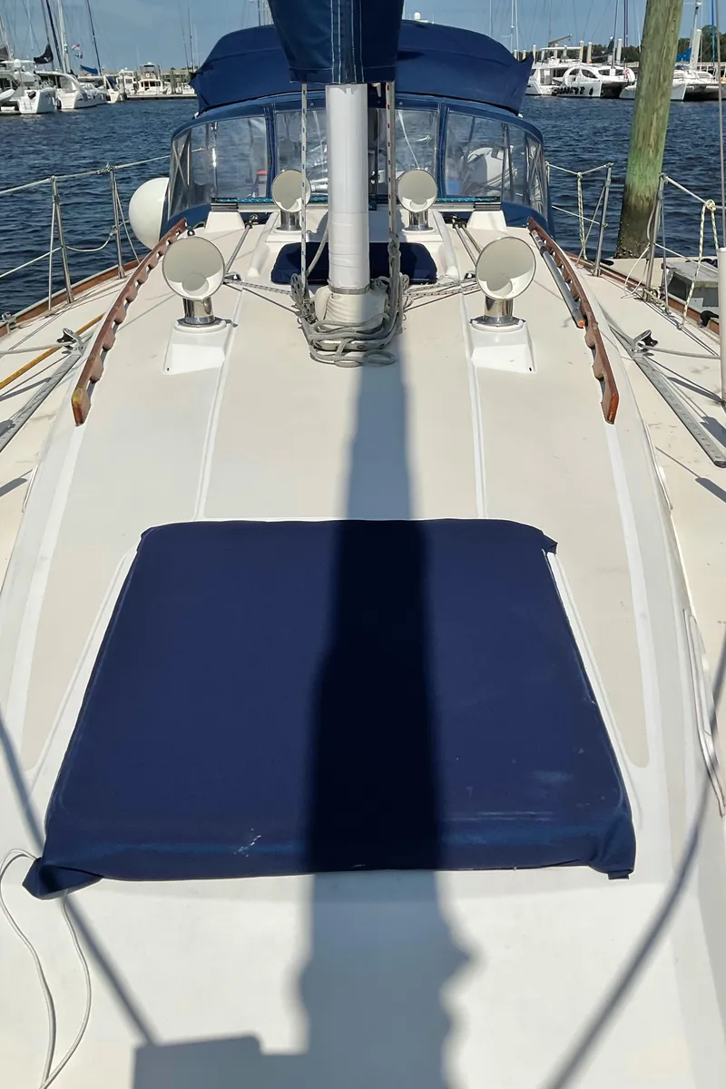 Slide: The Image of 1989 Sabre 34 MK II sailboat deck with blue cushions and marina background. - 4