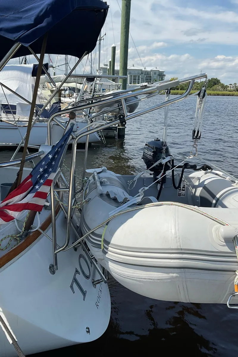 Slide: The Image of 1989 Sabre 34 MK II sailboat docked with dinghy and American flag. - 8