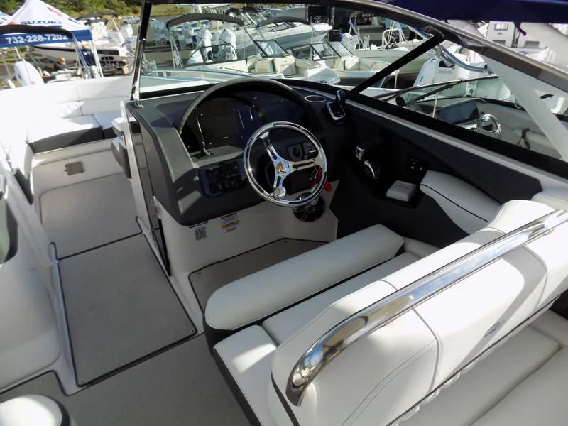 Slide: The Image of 2021 Regal 29 OBX boat interior with sleek steering and white seating. - 3