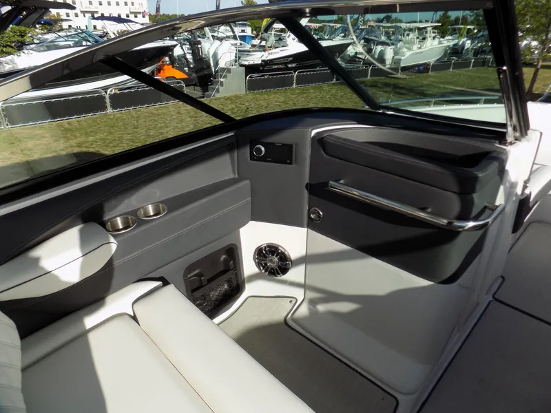Slide: The Image of 2021 Regal 29 OBX boat interior with seating, cup holders, and speaker. - 4