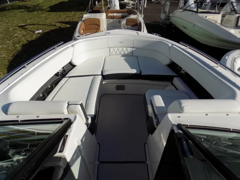 Slide: The Image of 2021 Regal 29 OBX boat interior with spacious white seating and modern design. - 7