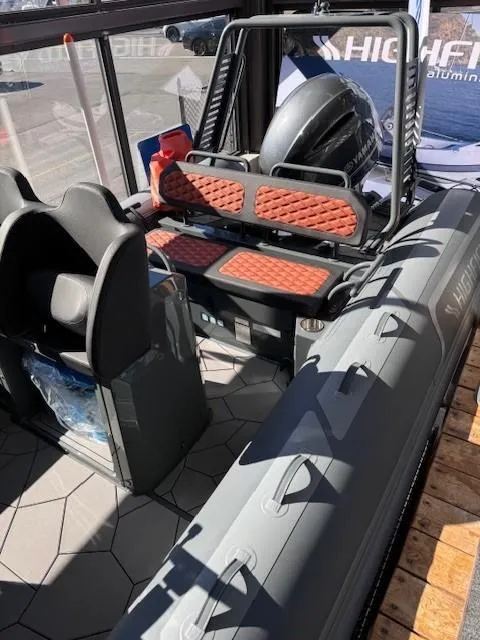 Slide: The Image of 2024 Highfield Sport 660 boat interior with seating and motor. - 3