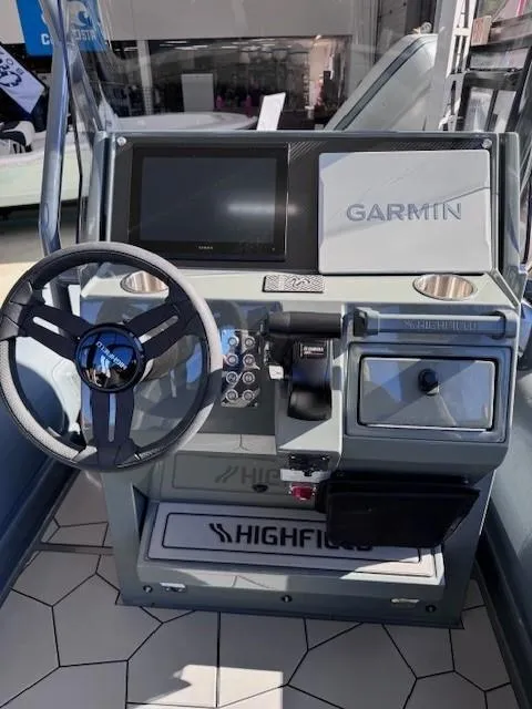 Slide: The Image of 2024 Highfield Sport 660 boat dashboard with Garmin navigation system. - 4