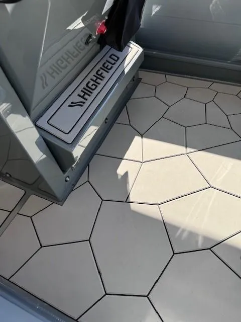 Slide: The Image of 2024 Highfield Sport 660 boat interior with geometric flooring design. - 8