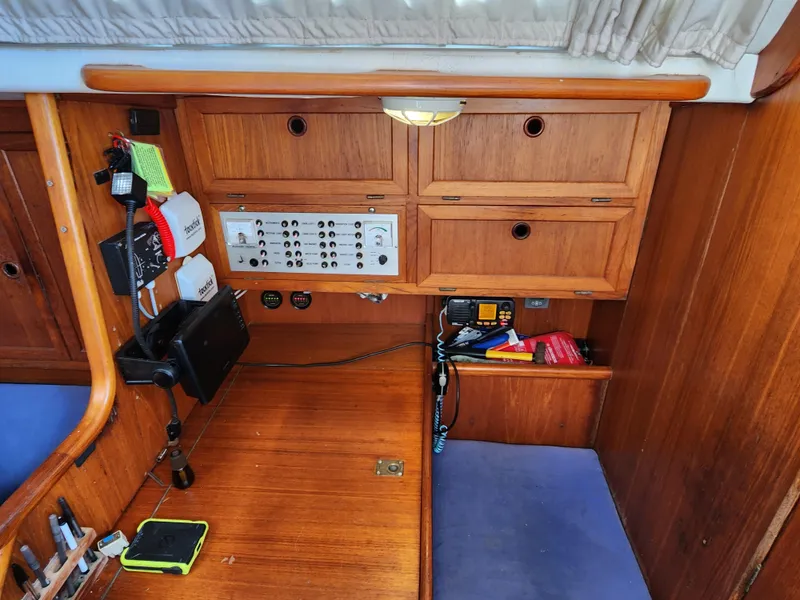 Slide: The Image of Navigation station of 1989 Granada 375 Atlantica sailboat with control panel and storage. - 10