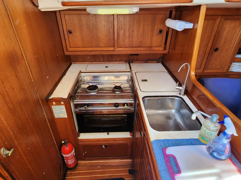 Slide: The Image of 1989 Granada 375 Atlantica boat kitchen with stove, sink, and wooden cabinets. - 12