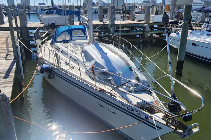 Slide: The Image of 1989 Granada 375 Atlantica sailboat docked at marina, sunny day, blue canopy. - 18