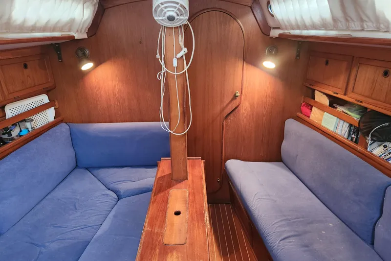 Slide: The Image of 1989 Granada 375 Atlantica sailboat interior with blue cushions and wooden finishes. - 22