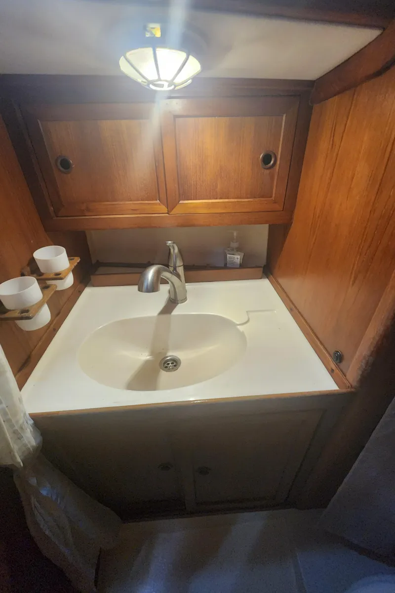 Slide: The Image of 1989 Granada 375 Atlantica bathroom sink with wooden cabinets and modern fixtures. - 25